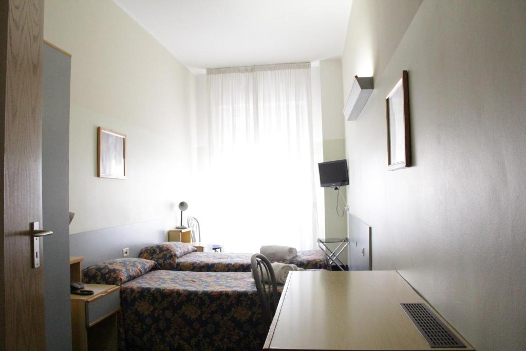 Łóżko lub łóżka w pokoju w obiekcie Hotel Lugano