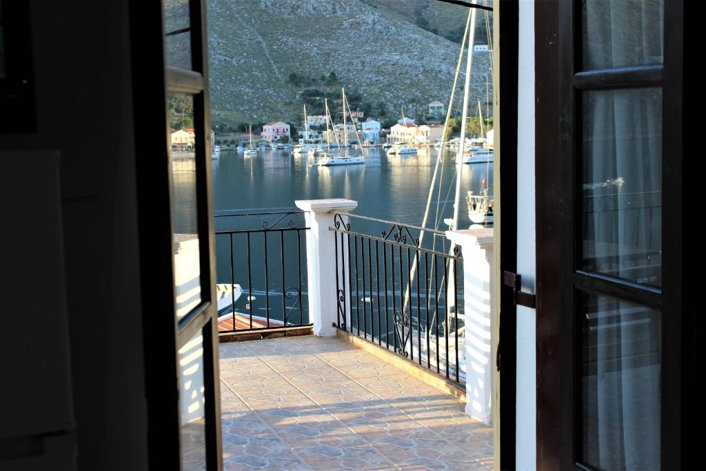 a view of a marina from a house balcony at Gompos Apartment - Cozy Apartment next to the sea - Amazing Sea View in Symi