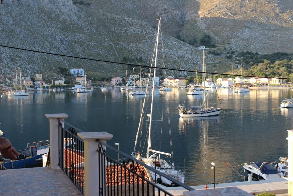 a group of boats are docked in a harbor at Gompos Apartment - Cozy Apartment next to the sea - Amazing Sea View in Symi