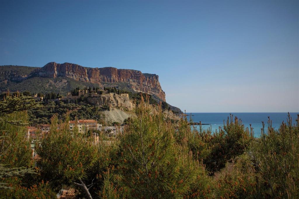a view of a mountain with the ocean behind it at SunRise Cassis in Cassis