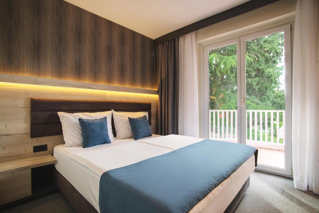 Postel nebo postele na pokoji v ubytování Hotel Haliaetum - San Simon Resort