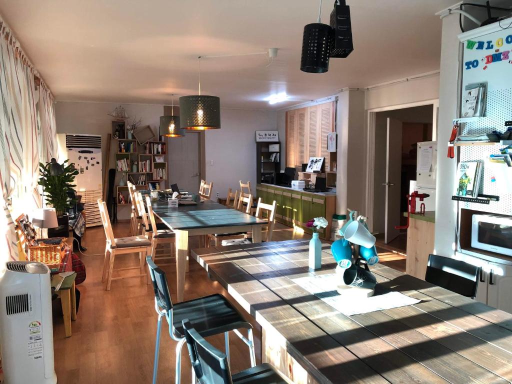 a dining room with a long table and chairs at The Guesthouse DMZ Stay in Paju