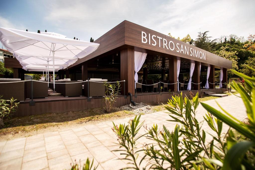 a building with a sign that reads biltoco san shop at Dependences - San Simon Resort in Izola