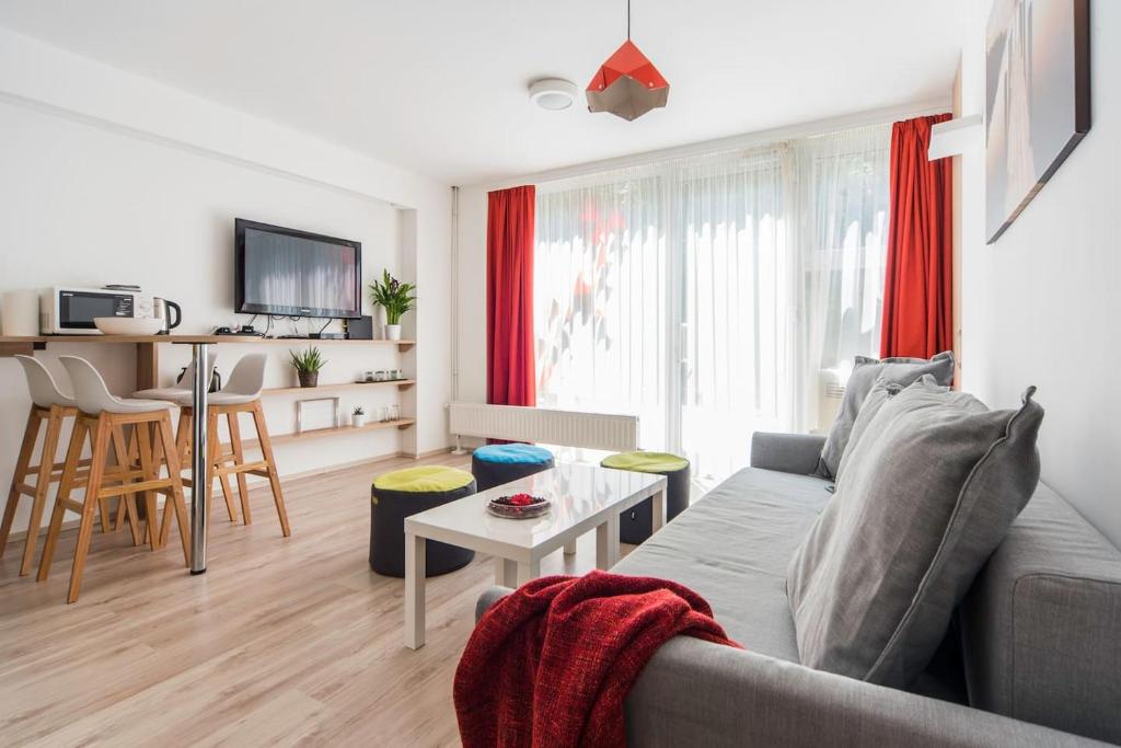 a living room with a couch and a table at Modern four bedroom apartment in Palace District in Budapest