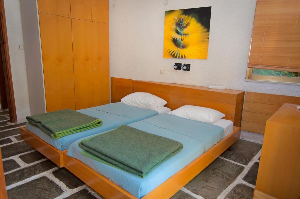 a bedroom with two beds with towels on them at Apollonia Hotel Apartments in Varkiza