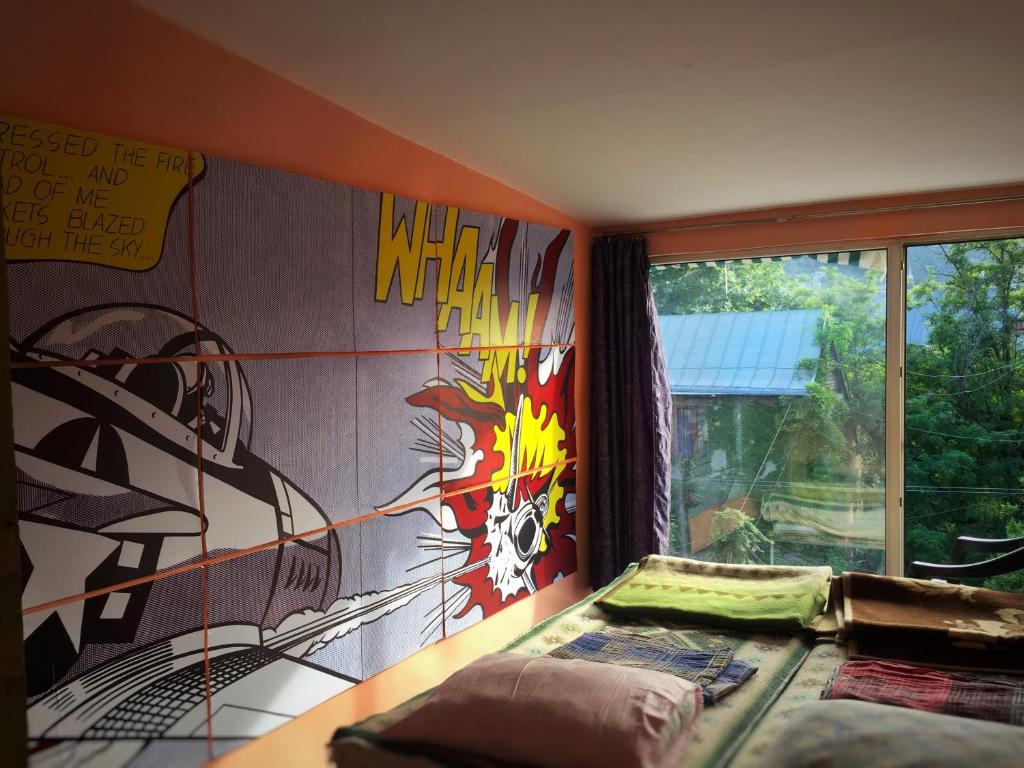 a bedroom with a wall covered in graffiti at Green Stairs Guest house in Tbilisi City