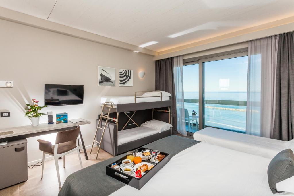 A bed or beds in a room at Nautilus Family Hotel