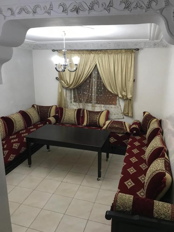 a living room with couches and a table at Appartement meublé sécurisé in Agadir