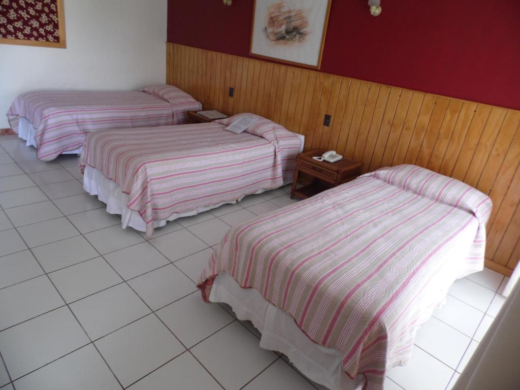 Postel nebo postele na pokoji v ubytování Hotel Manutara