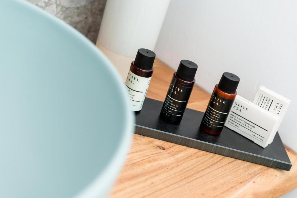 three bottles of essential oils sitting on a table at Hotel Villa Natassa in Skala Rachoniou