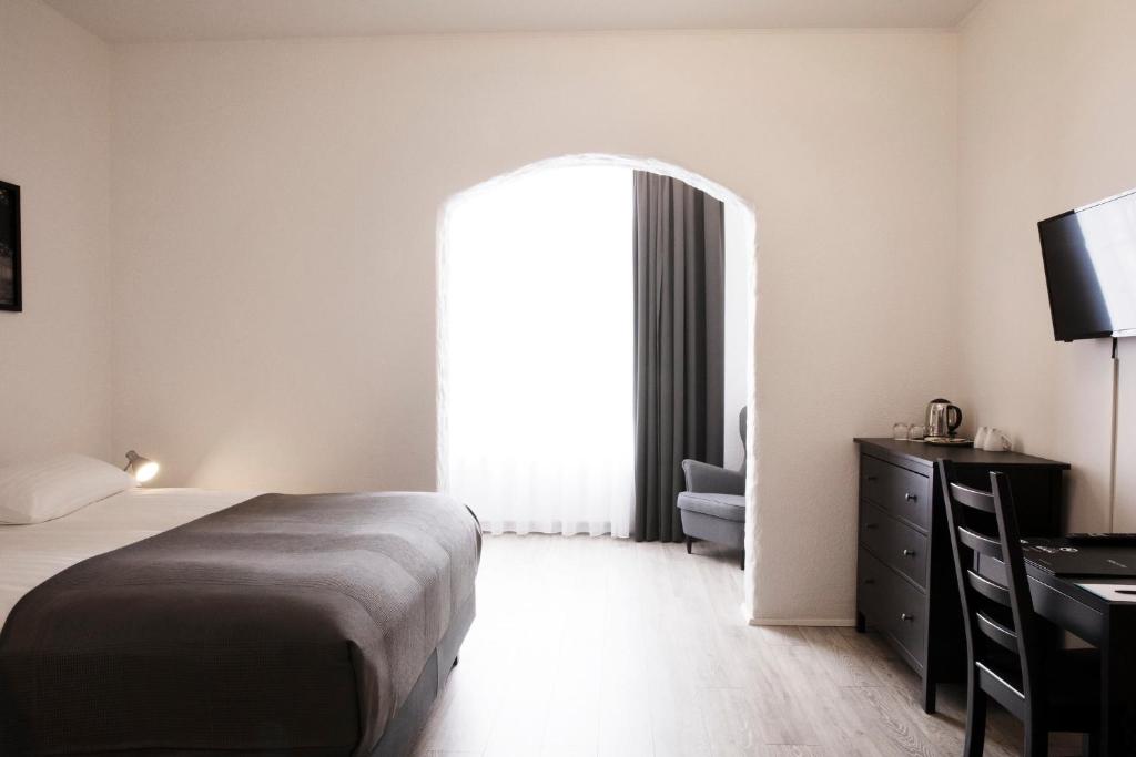 Rúm í herbergi á Fosshotel Rauðará