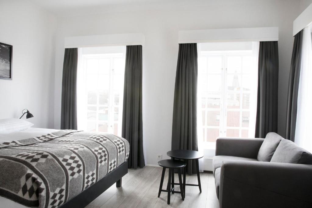 Rúm í herbergi á Fosshotel Rauðará