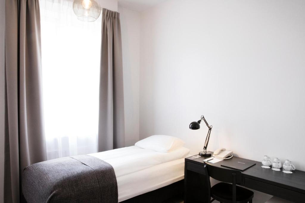 Rúm í herbergi á Fosshotel Rauðará