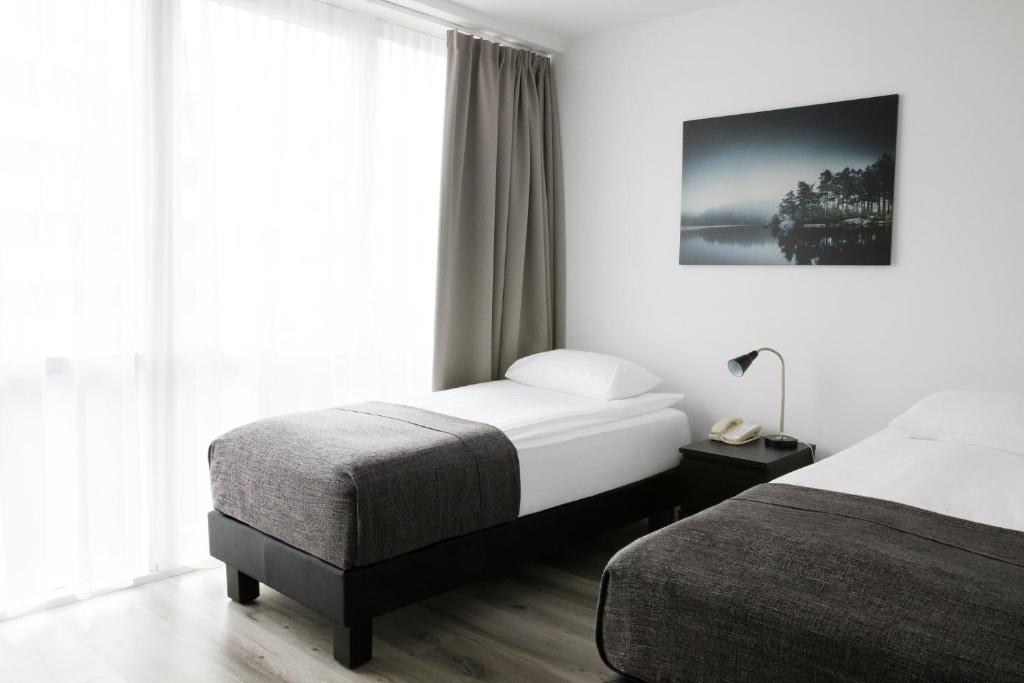 Rúm í herbergi á Fosshotel Rauðará