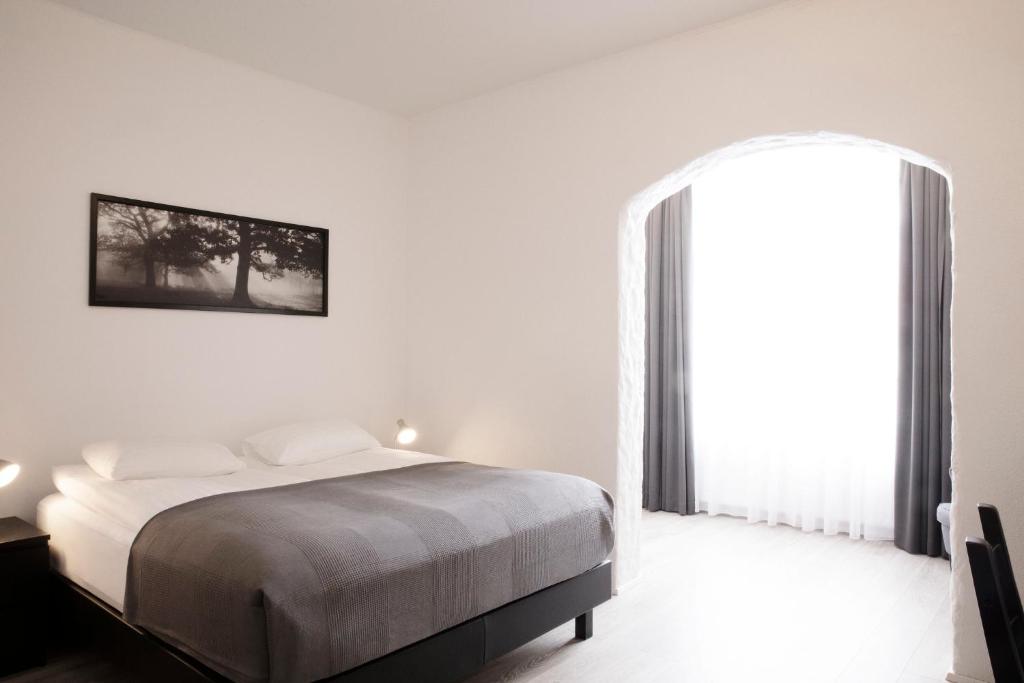 Rúm í herbergi á Fosshotel Rauðará