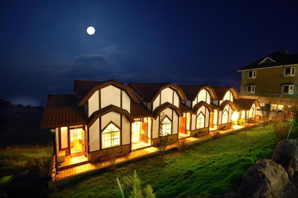 a large building at night with the moon in the sky at Sea of Clouds Vacation Villa in Renai