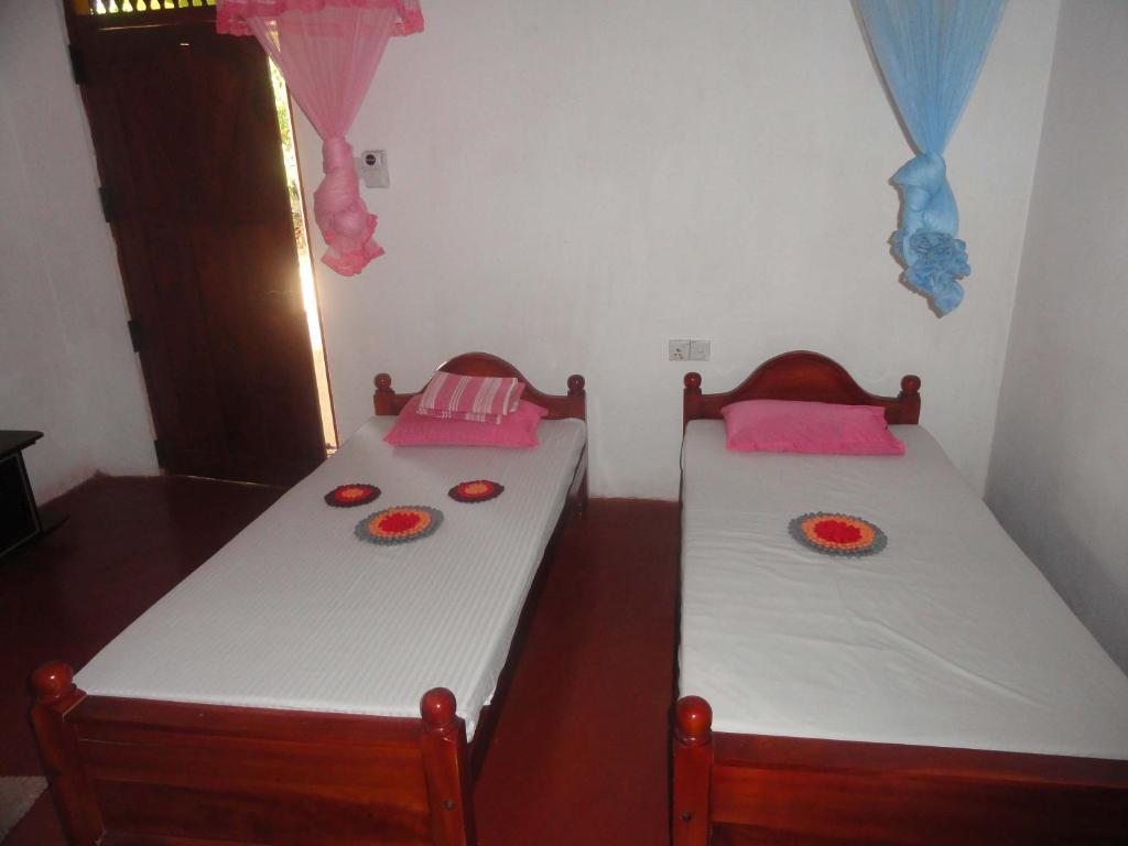 Postel nebo postele na pokoji v ubytování Lak Nilla Guest House