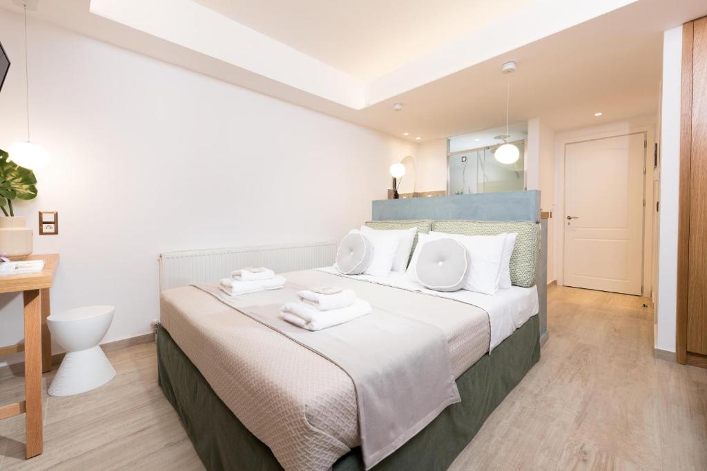 a bedroom with a large bed with white pillows at Hotel Villa Natassa in Skala Rachoniou