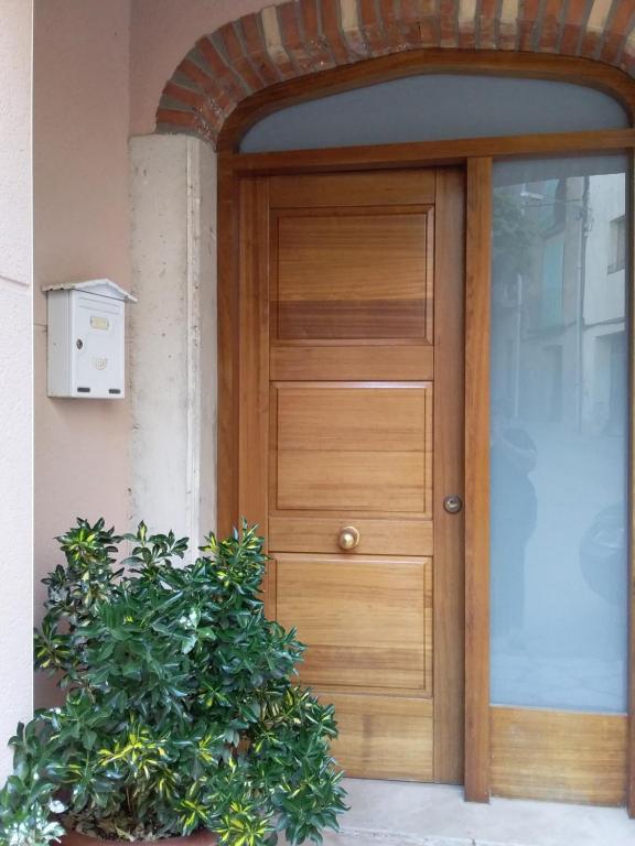 a wooden door in front of a building at Loft Castelló in Castelló de Farfaña