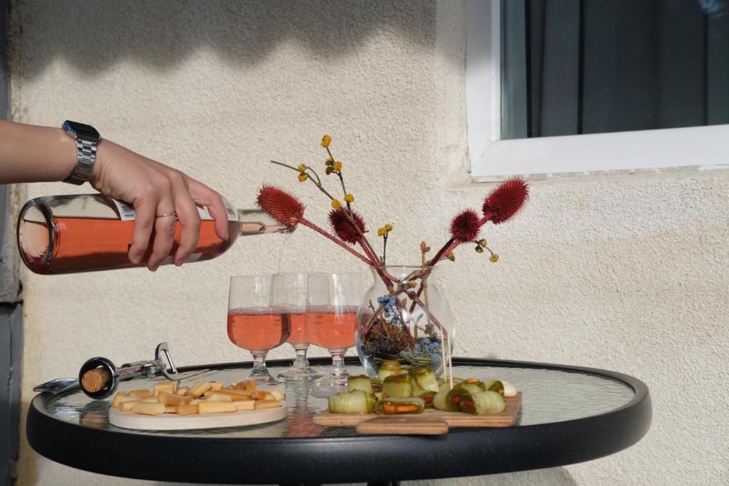 a table with a tray of cheese and wine glasses at BMG (Be My Guest) in Mtskheta