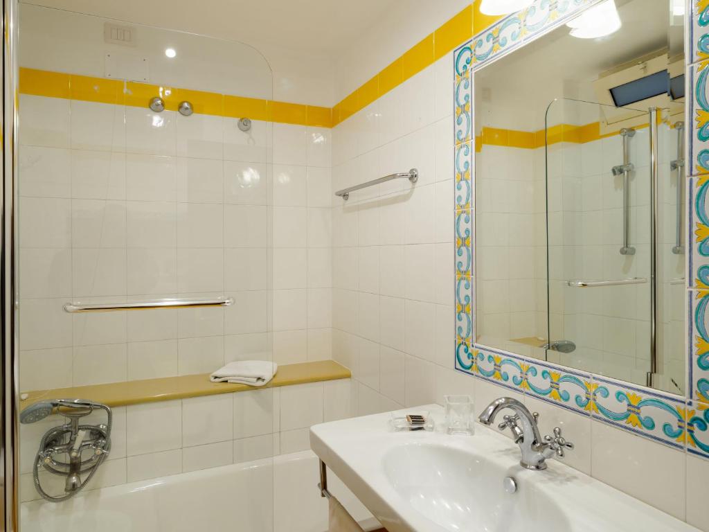a bathroom with a sink and a mirror at Hotel Sirius in Taormina