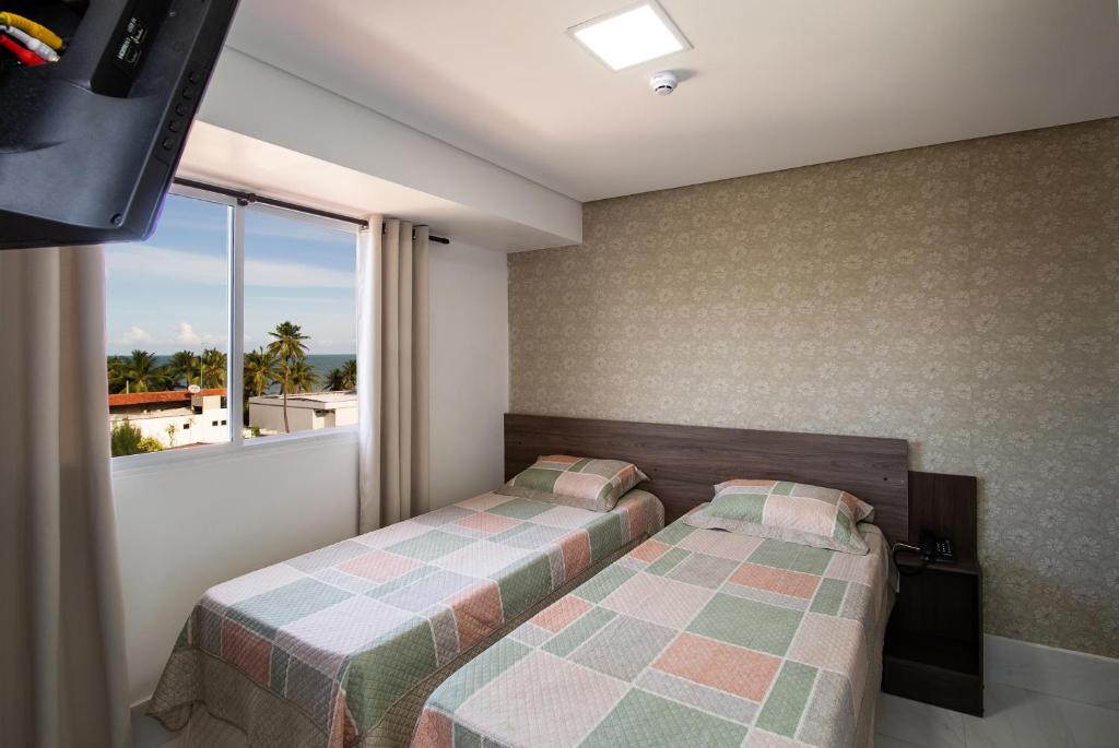 Cama ou camas em um quarto em Tambau Beach Hotel