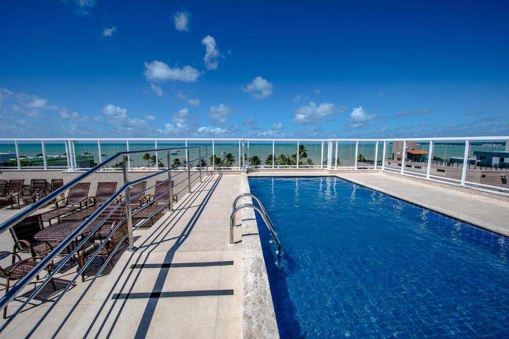 a balcony with a swimming pool on a cruise ship at Tambau Beach Hotel in João Pessoa