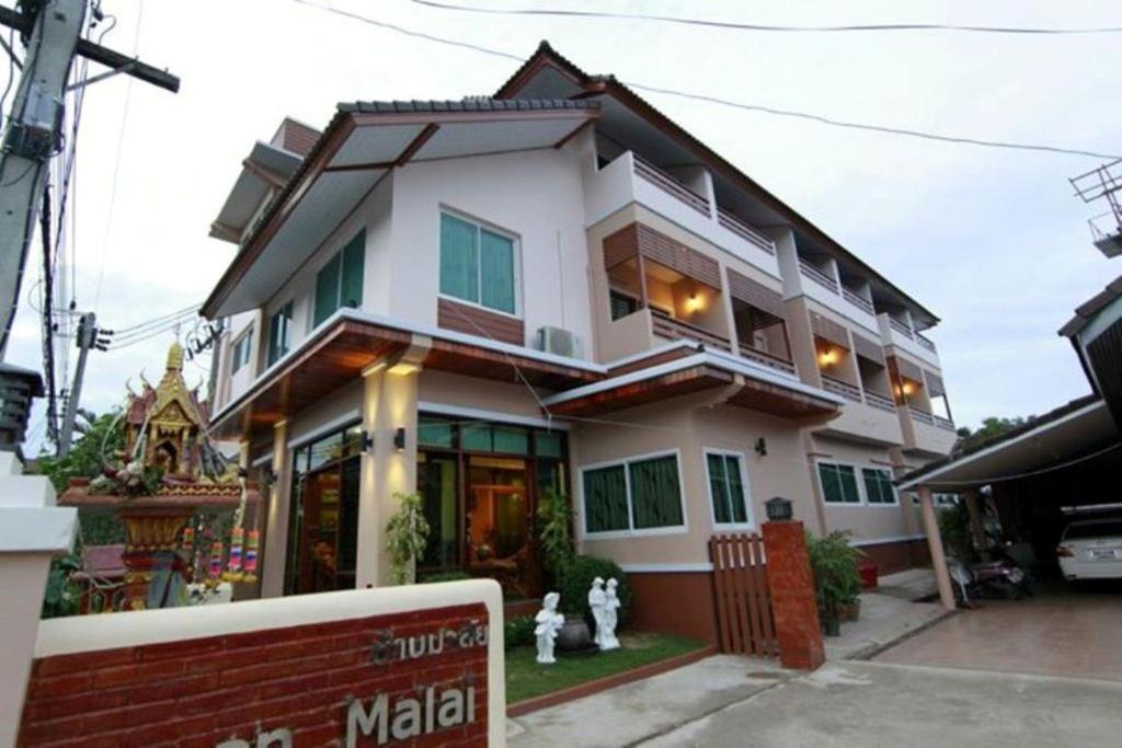 una casa bianca con un cartello davanti di Baanmalai Hotel Chiangrai a Chiang Rai