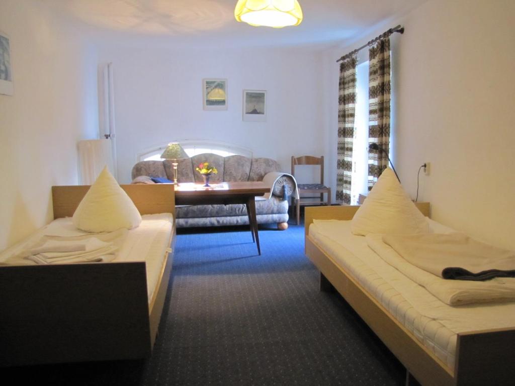 a room with two beds and a living room at Haus Annaberg in Bonn
