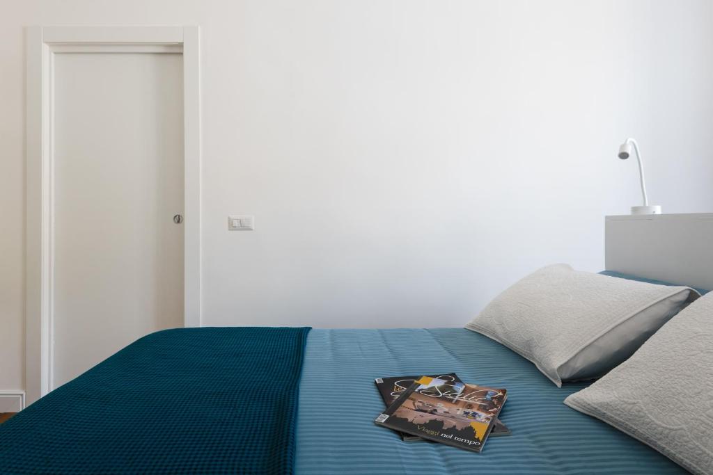 Postel nebo postele na pokoji v ubytování D-Home Ortigia