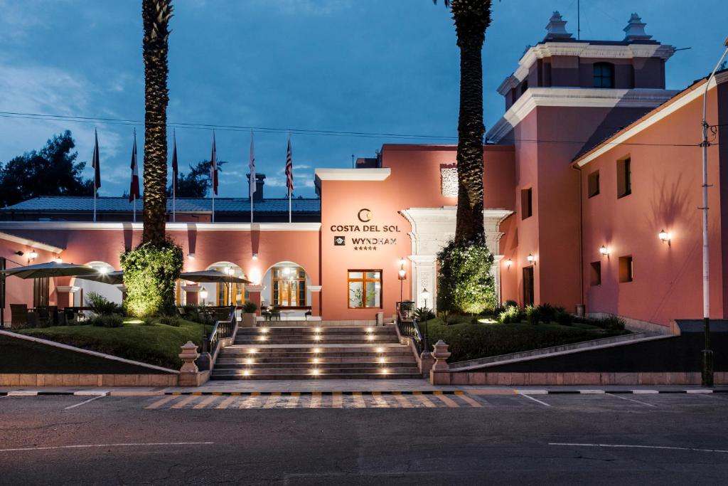 a large building with a clock on the side of it at Wyndham Costa del Sol Arequipa in Arequipa
