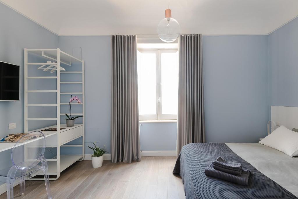 Postel nebo postele na pokoji v ubytování D-Home Ortigia