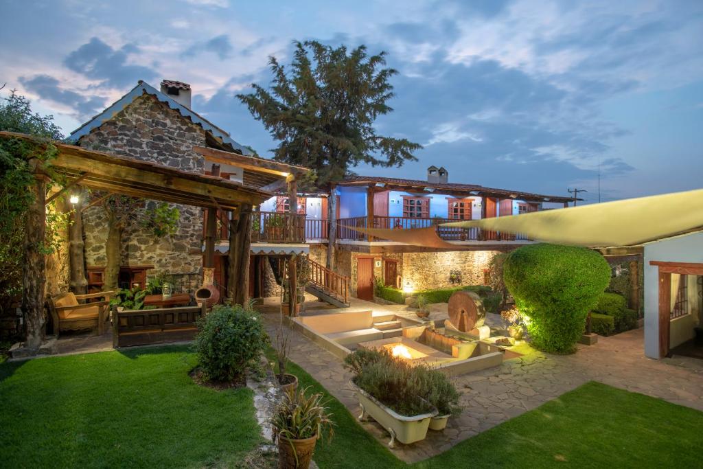 an exterior view of a house with a garden at La Casa Azul Huasca in Huasca de Ocampo