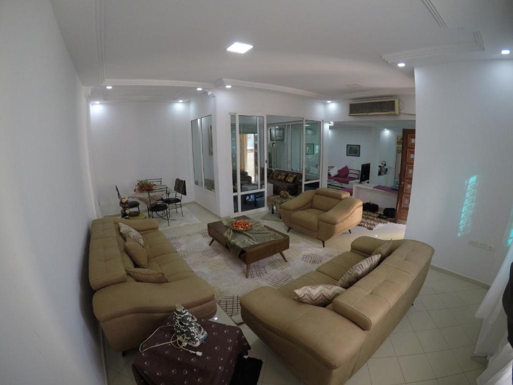 a living room with two couches and a couch and a table at Villa Curubis Korba in Korba