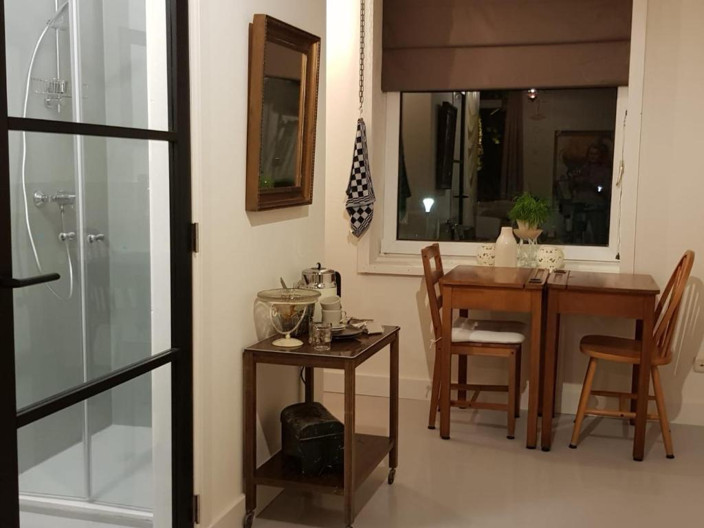 a kitchen with a table and chairs and a dining room at B&B The Project in Heerlen
