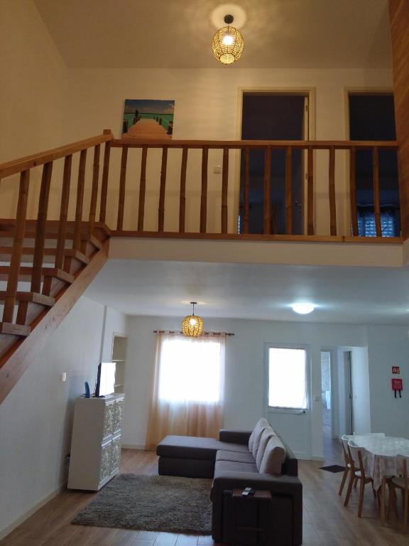 a living room with a couch and a staircase at Sweet Dreams near Beaches in Ponta Delgada
