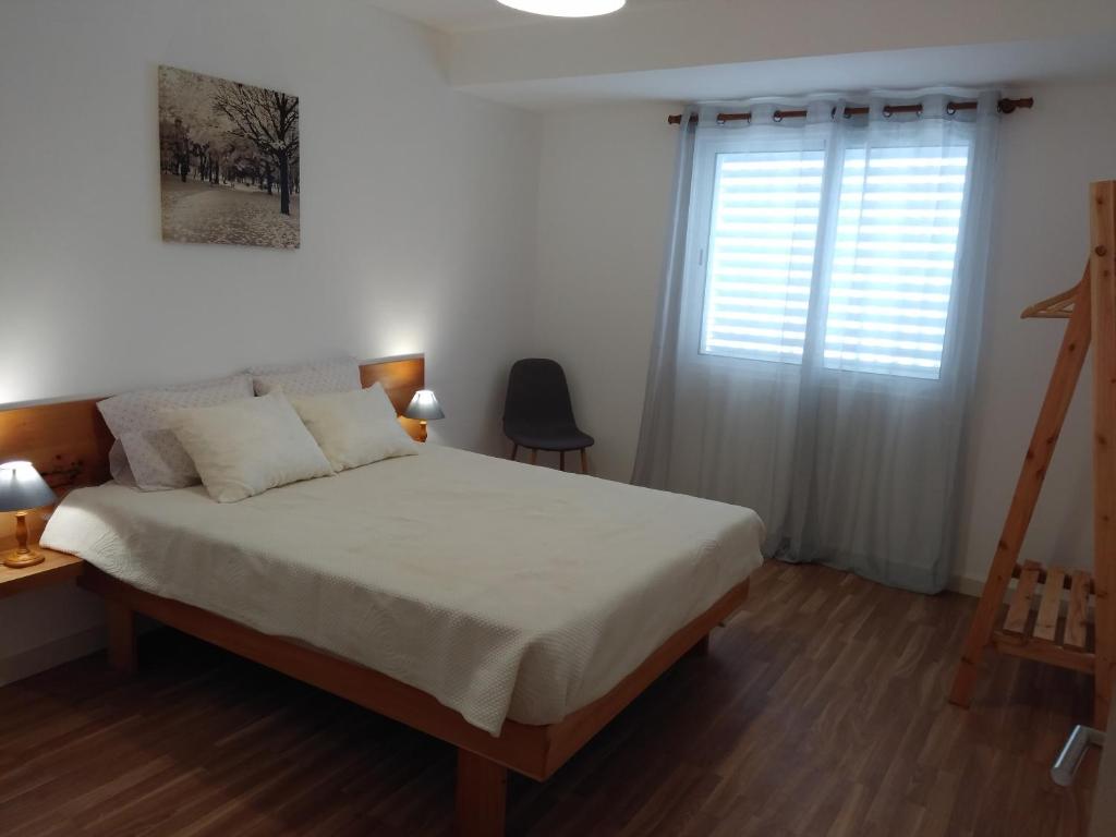 a bedroom with a large bed and a window at Sweet Dreams near Beaches in Ponta Delgada