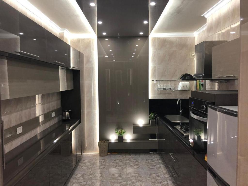 a kitchen with stainless steel appliances and a hallway at Apartment at Milsa Nasr City, Building No. 30 in Cairo