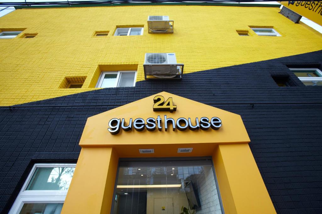 a yellow building with a sign for a guest house at 24 Guesthouse Seoul Station in Seoul