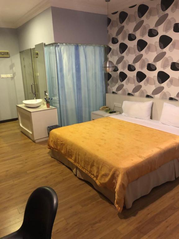 Postel nebo postele na pokoji v ubytování King Park Hotel Tawau