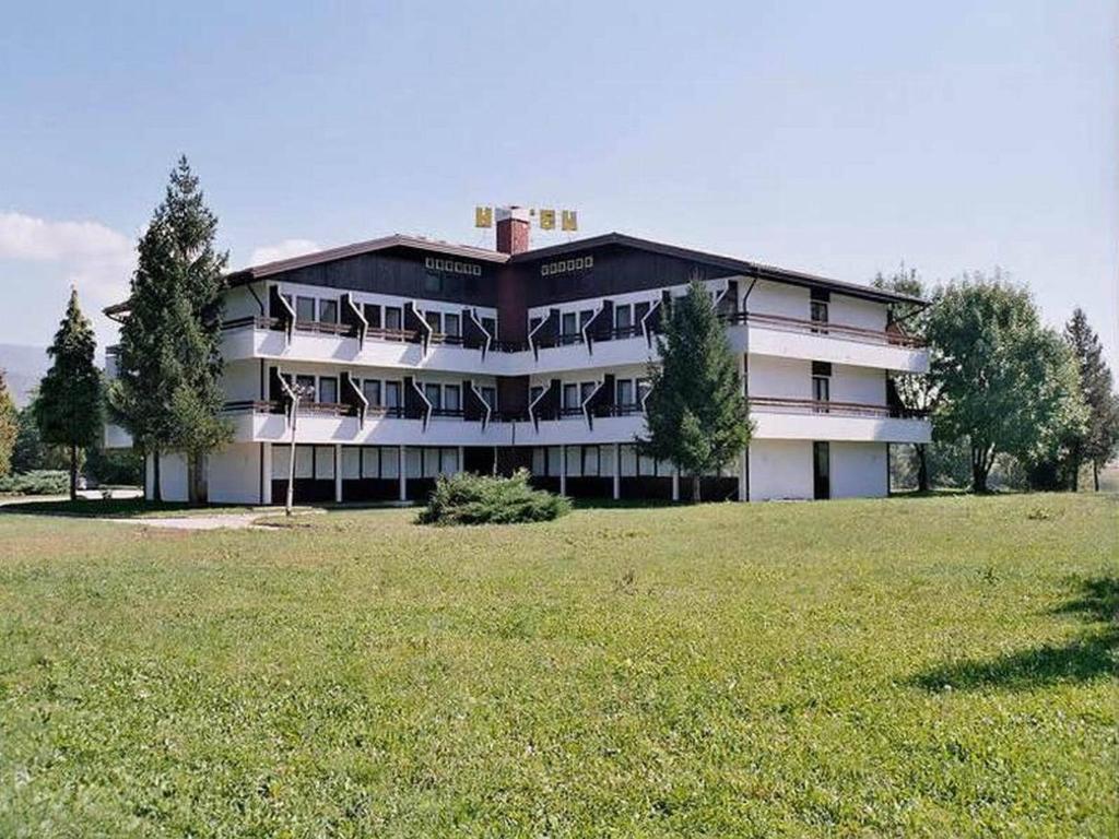a large building with a field in front of it at Hotel Ada in Bihać