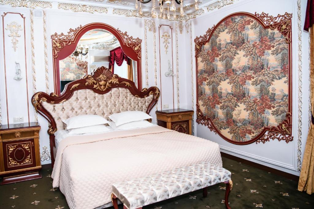 a bedroom with a white bed and a mirror at Lion Hotel in Astana