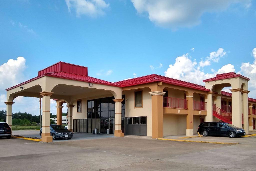 a building with cars parked in a parking lot at Econo Lodge Inn & Suites West - Energy Corridor in Houston
