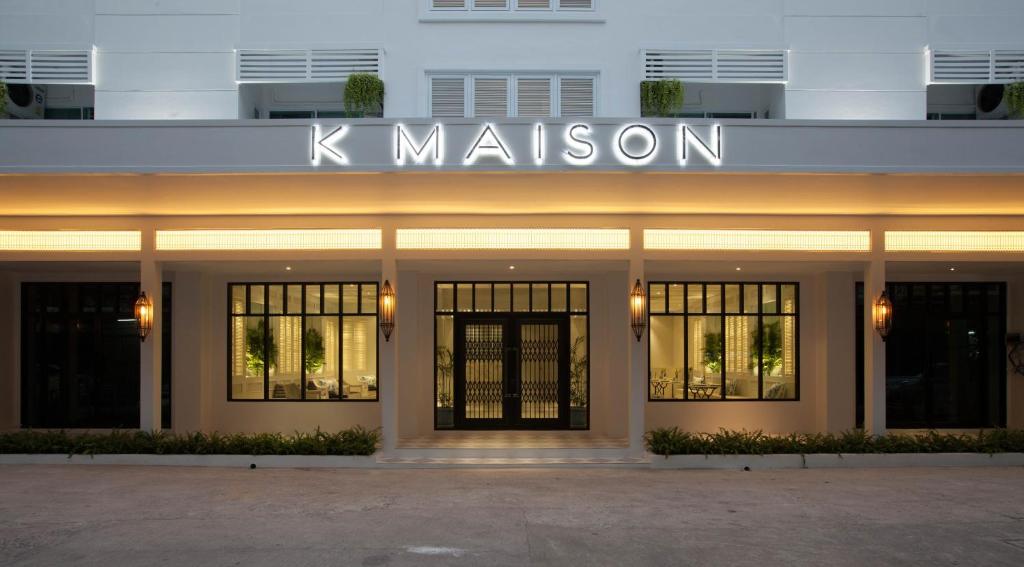 a building with a sign that reads k mission at K Maison Boutique Hotel in Bangkok