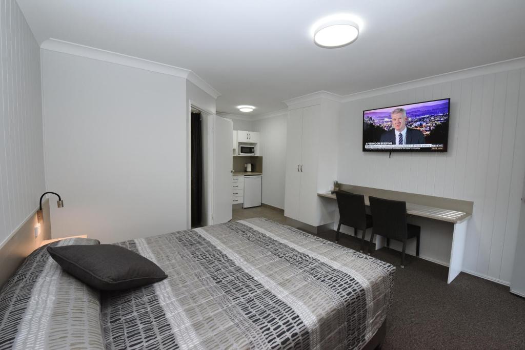 Postel nebo postele na pokoji v ubytování Raintree Motel Biloela