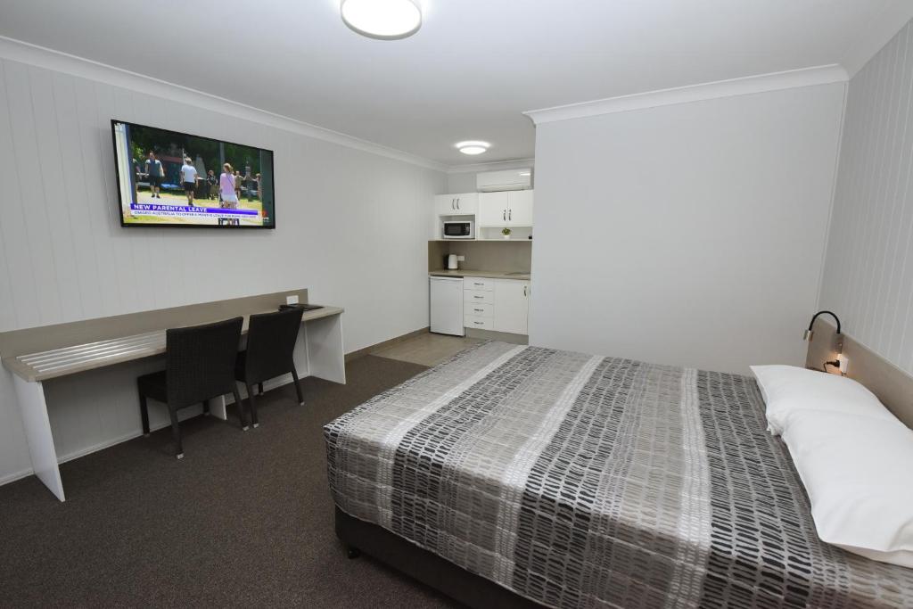 Postel nebo postele na pokoji v ubytování Raintree Motel Biloela