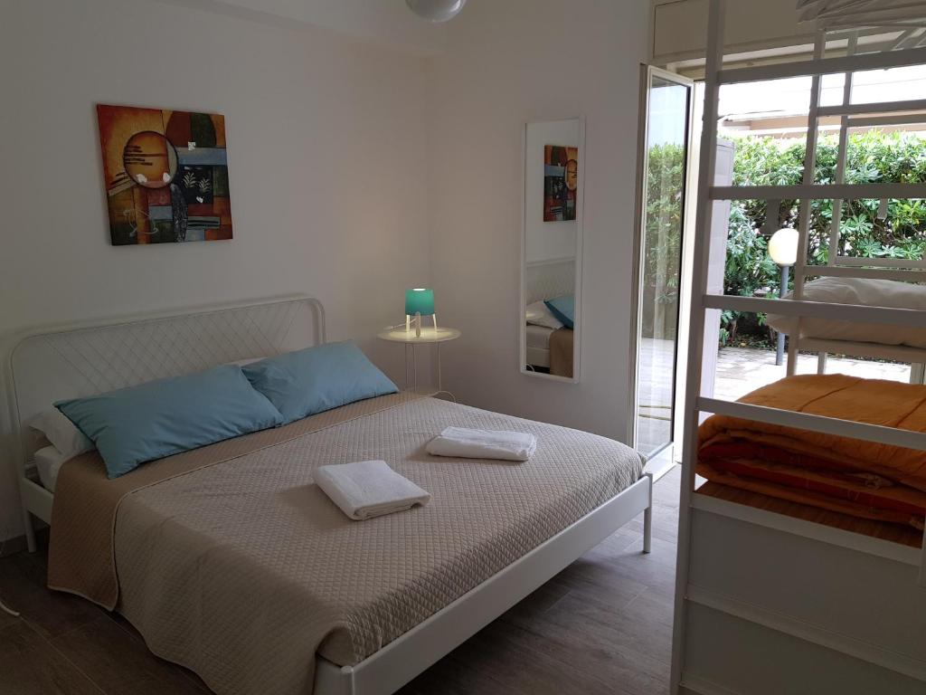 a bedroom with a bed with two towels on it at La casa dei sassi holiday house in Giardini Naxos