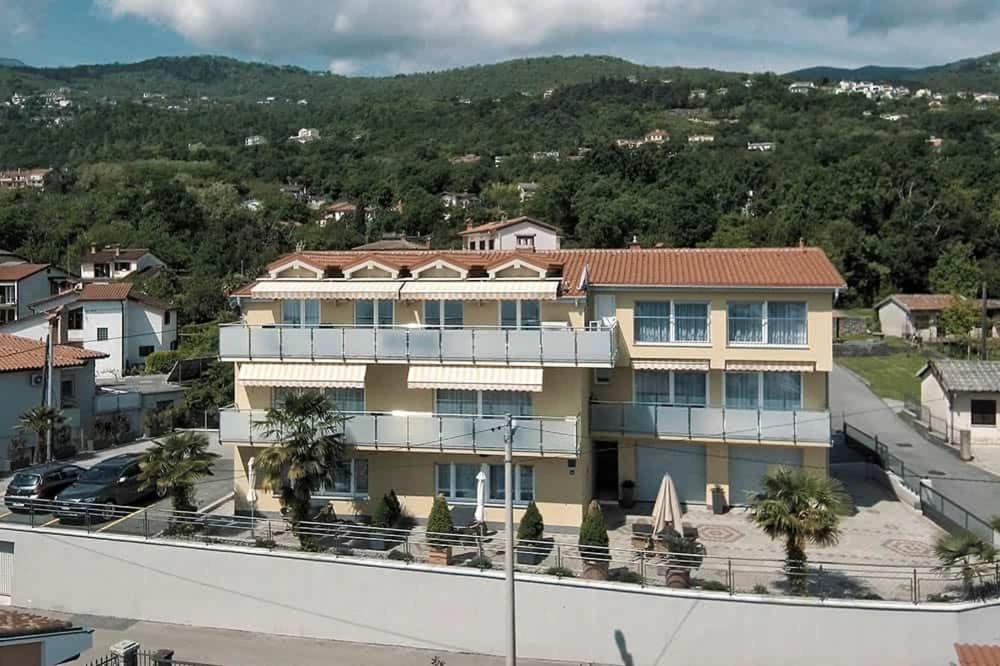 a view of a building with a mountain in the background at Villa Martina in Ika