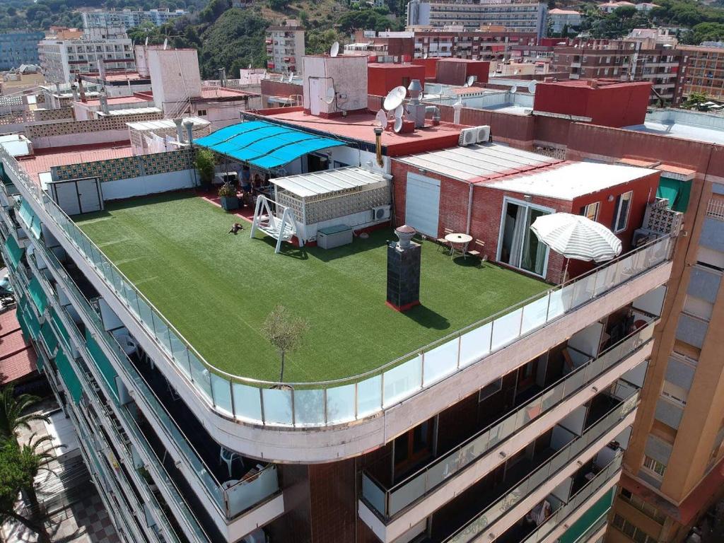 a building with a green lawn on top of it at Calella Skyline in Calella