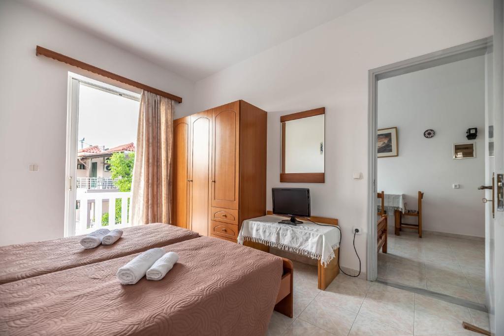 Postel nebo postele na pokoji v ubytování Hotel Ikaros